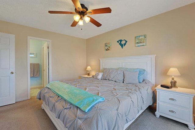 carpeted bedroom featuring ceiling fan and connected bathroom