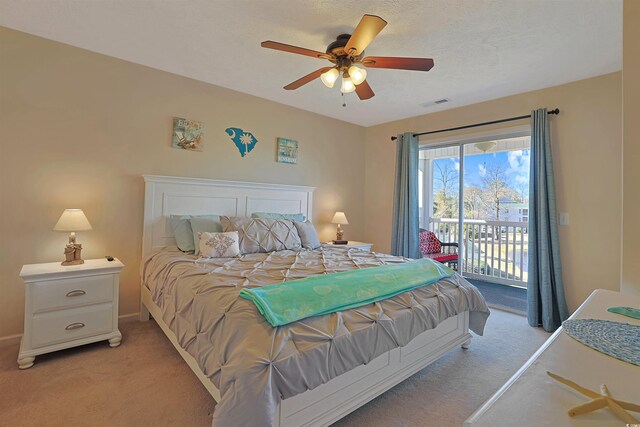 bedroom with ceiling fan, a textured ceiling, light carpet, and access to outside