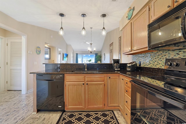 kitchen with sink, dark stone countertops, kitchen peninsula, pendant lighting, and black appliances