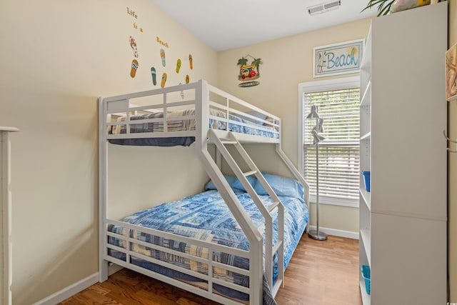bedroom with hardwood / wood-style flooring