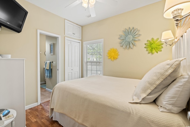 bedroom with ceiling fan, dark hardwood / wood-style flooring, and a closet