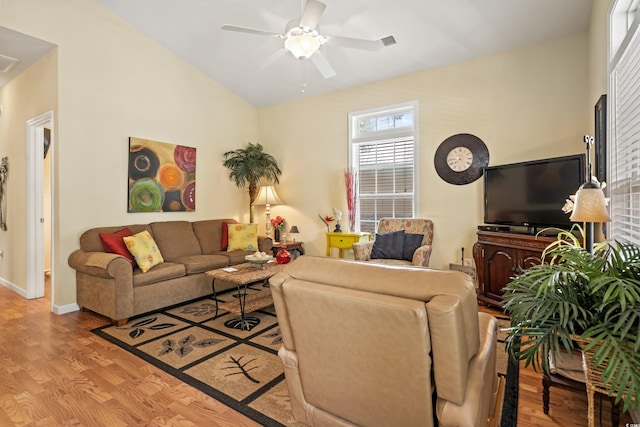 living room featuring lofted ceiling, light hardwood / wood-style floors, and ceiling fan