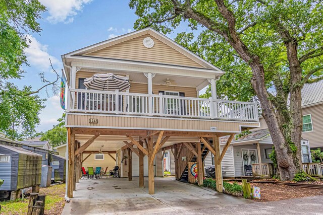 view of front of house with a carport, ceiling fan, and a porch