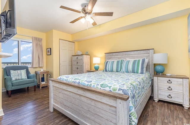 bedroom featuring ceiling fan, dark hardwood / wood-style floors, and access to outside