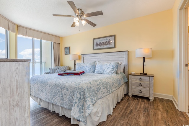 bedroom with dark wood-type flooring, ceiling fan, access to exterior, floor to ceiling windows, and a textured ceiling