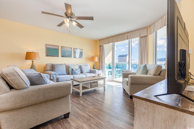 living room featuring hardwood / wood-style flooring, ceiling fan, and expansive windows