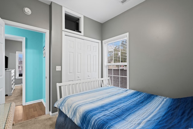 bedroom with hardwood / wood-style flooring and a closet