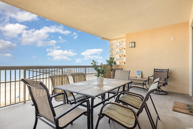 balcony with a beach view and a water view