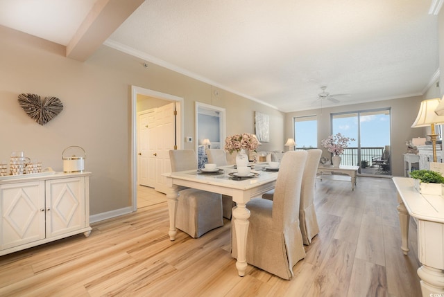 dining room featuring crown molding, ceiling fan, and light wood-type flooring