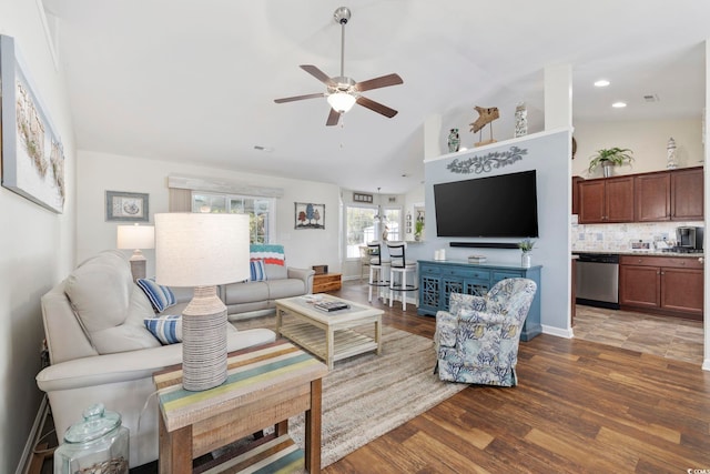 living room with ceiling fan, dark hardwood / wood-style floors, and high vaulted ceiling