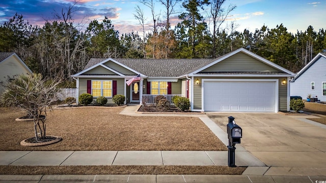 single story home with a garage and covered porch