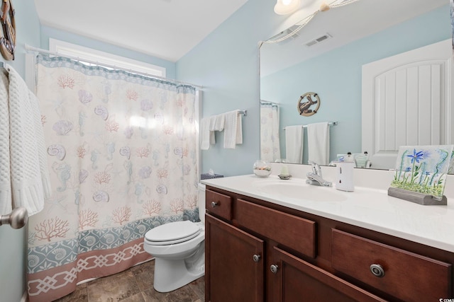 bathroom with vanity, a shower with shower curtain, and toilet