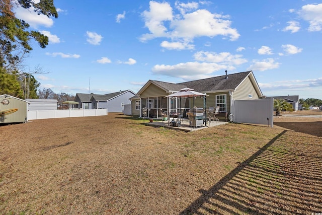 back of house with a yard and a patio area