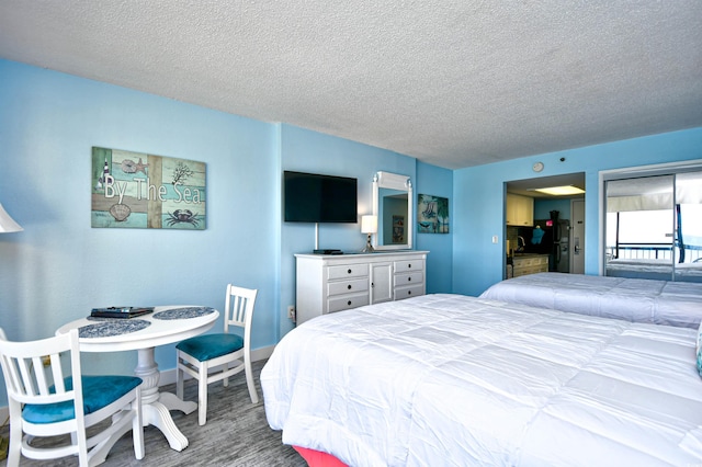 bedroom with hardwood / wood-style floors and a textured ceiling