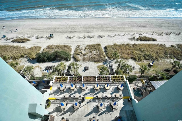 bird's eye view featuring a water view and a beach view