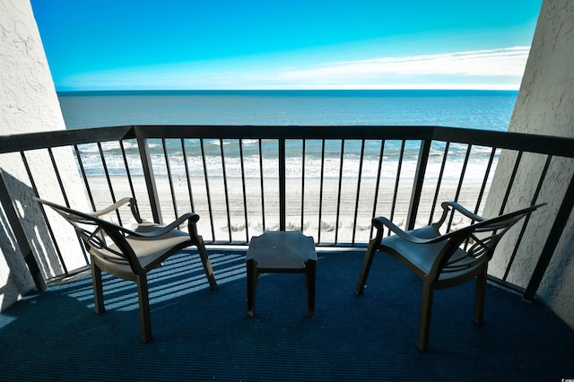 balcony with a view of the beach and a water view