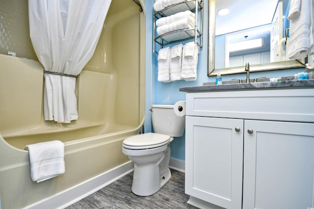 full bathroom featuring shower / bath combination, wood-type flooring, vanity, and toilet