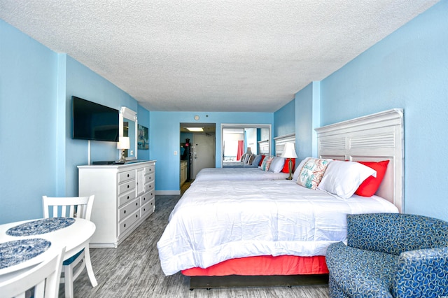 bedroom featuring hardwood / wood-style flooring and a textured ceiling