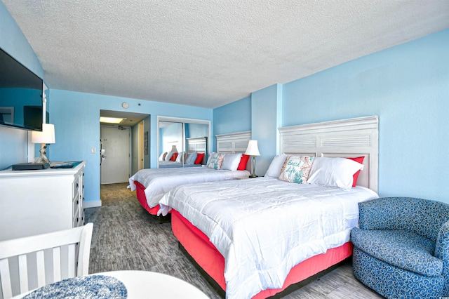 bedroom with a textured ceiling and a closet