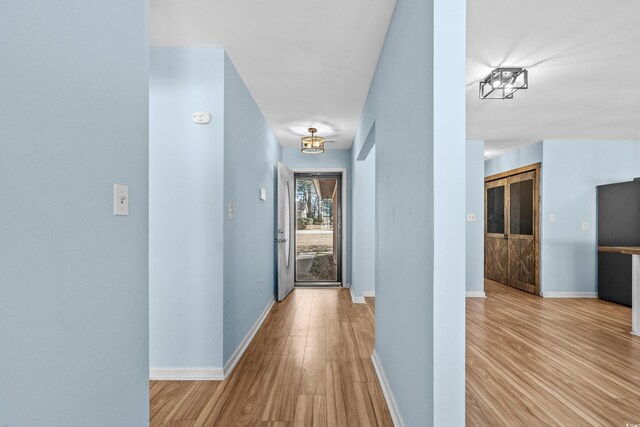 corridor featuring light hardwood / wood-style flooring