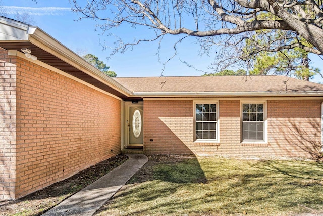 entrance to property with a lawn