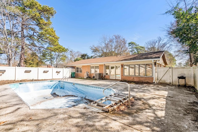 view of pool featuring a patio area and central air condition unit