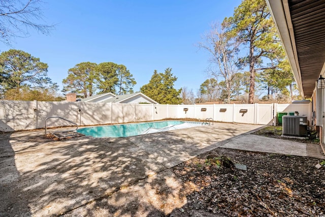 view of swimming pool featuring cooling unit and a patio