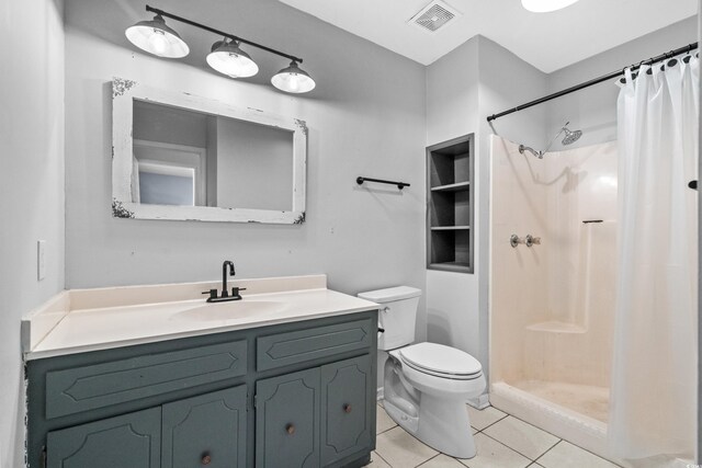 bathroom featuring tile patterned flooring, vanity, toilet, and a shower with shower curtain