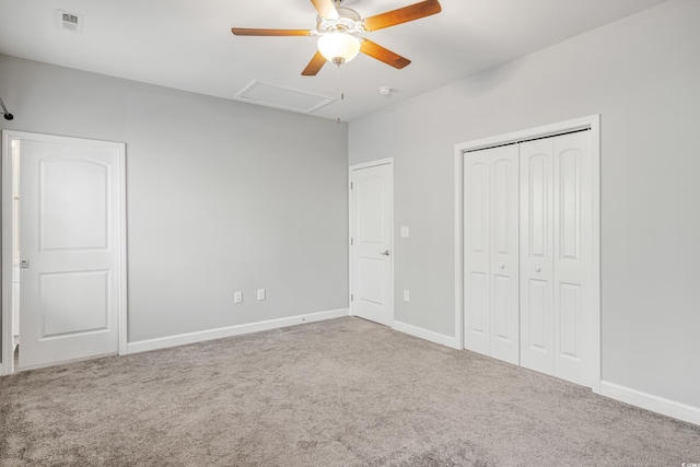 unfurnished bedroom featuring ceiling fan, a closet, and light carpet