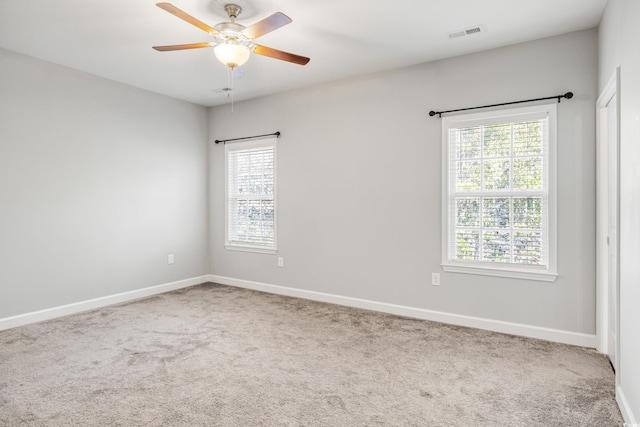 carpeted empty room featuring ceiling fan