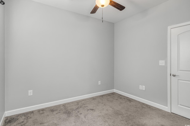 spare room with ceiling fan and carpet