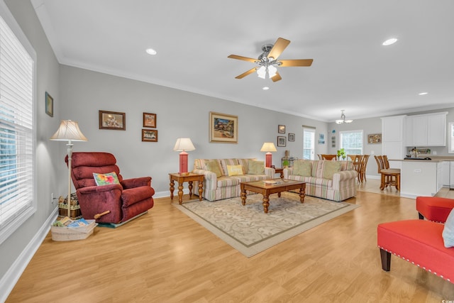 living room with recessed lighting, baseboards, light wood-style flooring, and crown molding