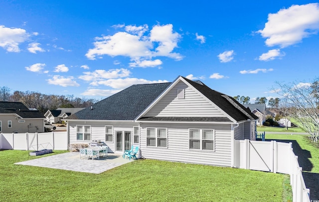 back of property featuring a lawn and a patio area