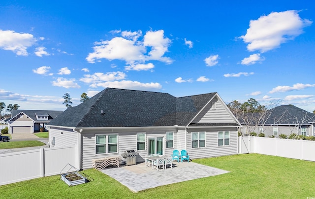 back of property featuring a mountain view, a lawn, and a patio area