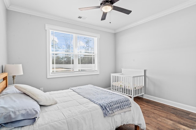 bedroom featuring crown molding, ceiling fan, and dark wood-type flooring