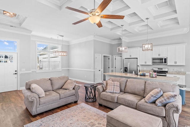 living room featuring coffered ceiling, dark hardwood / wood-style floors, sink, and crown molding