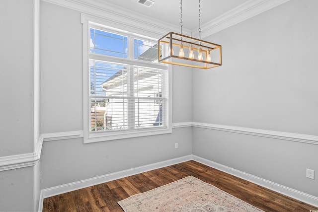 unfurnished dining area featuring crown molding, dark hardwood / wood-style flooring, and a notable chandelier