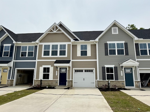 2065 NW Parow Ln NW Unit D, Calabash, NC 28467 - view of front of home featuring stone siding, driveway, board and batten siding, and roof with shingles