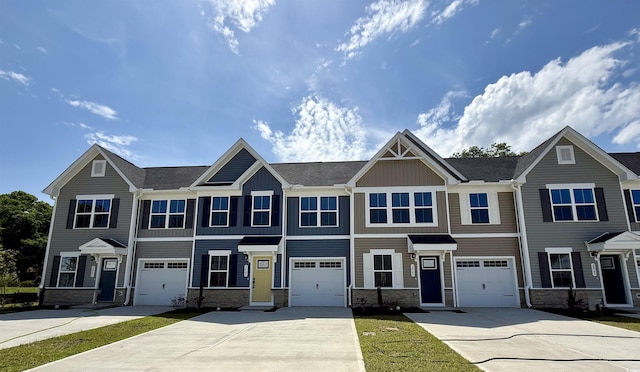 2065 NW Parow Ln NW Unit D, Calabash, NC 28467 - view of front of home featuring driveway, stone siding, an attached garage, and board and batten siding