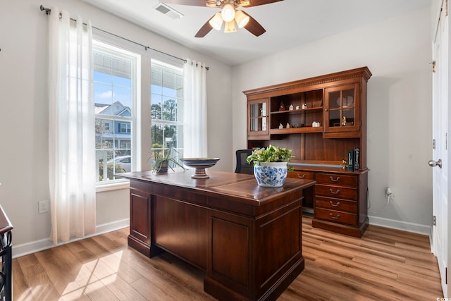 office with ceiling fan and light hardwood / wood-style floors