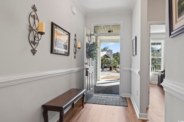 entryway featuring crown molding and hardwood / wood-style flooring