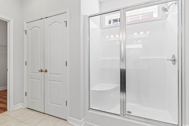 bathroom featuring tile patterned flooring and an enclosed shower