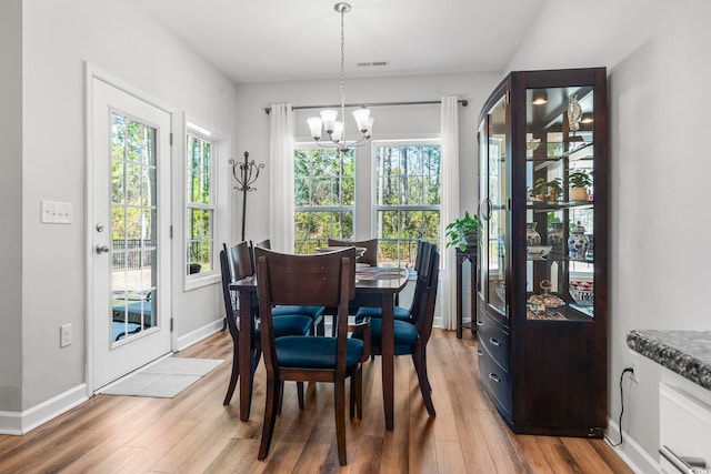 dining room with an inviting chandelier and hardwood / wood-style floors