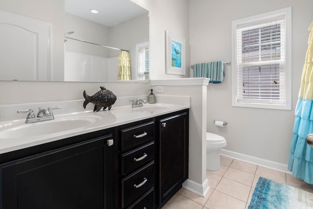 bathroom with vanity, curtained shower, tile patterned floors, and toilet