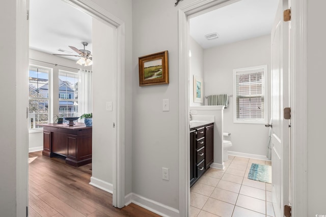 bathroom with vanity, wood-type flooring, ceiling fan, and toilet