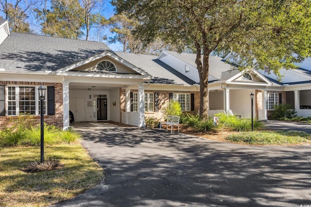 489-3 Golden Bear Dr Unit 3, Pawleys Island, SC 29585 - view of front of property with brick siding, driveway, a carport, and roof with shingles