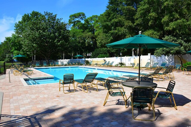 489-3 Golden Bear Dr Unit 3, Pawleys Island, SC 29585 - community pool with a patio and view of wooded area