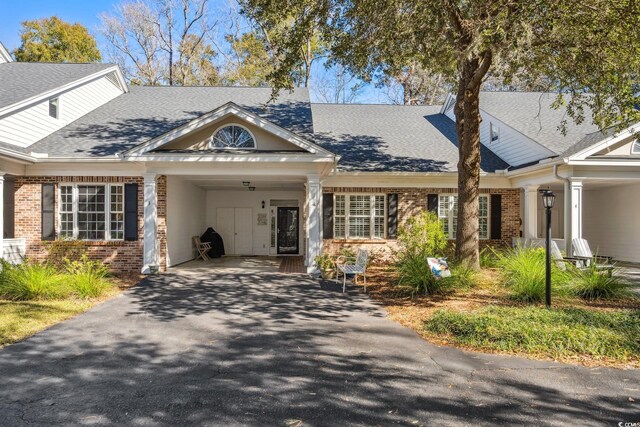 489-3 Golden Bear Dr Unit 3, Pawleys Island, SC 29585 - view of front of property featuring brick siding, driveway, a carport, and a shingled roof