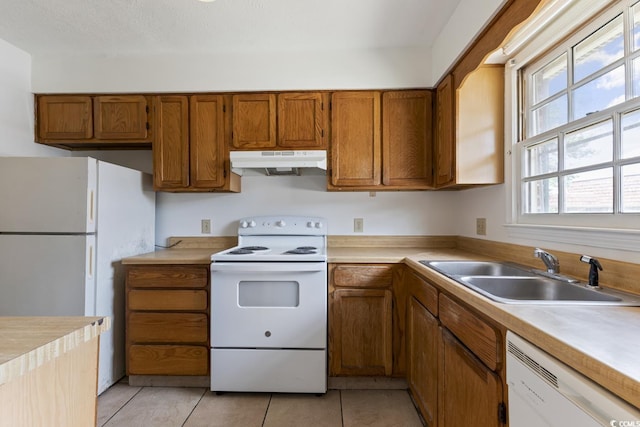 1025 Carolina Rd Unit I-7, Conway, SC 29526 - kitchen featuring white appliances, under cabinet range hood, a sink, and brown cabinets