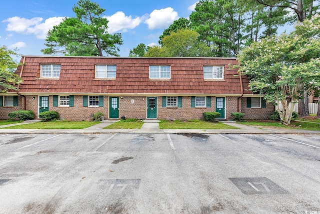 1025 Carolina Rd Unit I-7, Conway, SC 29526 - view of front of property with uncovered parking, mansard roof, and brick siding